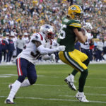 Green Bay Packers tight end Robert Tonyan catches a 20-yard touchdown pass ahead of New England Patriots safety Devin McCourty (32) during the second half of an NFL football game, Sunday, Oct. 2, 2022, in Green Bay, Wis. (AP Photo/Mike Roemer)
