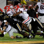 
              Georgia quarterback Stetson Bennett (13) is sacked by a host of Missouri defenders during the first half of an NCAA college football game Saturday, Oct. 1, 2022, in Columbia, Mo. (AP Photo/L.G. Patterson)
            