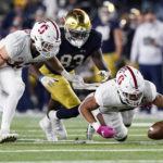 
              Stanford safety Jonathan McGill, right, recovers a fumble past cornerback Ethan Bonner, left, and Notre Dame wide receiver Jayden Thomas during the second half of an NCAA college football game in South Bend, Ind., Saturday, Oct. 15, 2022. Stanford won 16-14. (AP Photo/Nam Y. Huh)
            