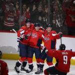 
              Washington Capitals center Lars Eller, second from left, celebrates his goal with center Aliaksei Protas (59), defenseman John Carlson (74), defenseman Dmitry Orlov (9) and right wing Anthony Mantha (39) during the third period of an NHL hockey game against the Los Angeles Kings, Saturday, Oct. 22, 2022, in Washington. (AP Photo/Nick Wass)
            
