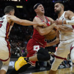 
              Miami Heat guards Duncan Robinson (55) and Max Strus (31) defend against Chicago Bulls guard Alex Caruso (6) during the first half of an NBA basketball game Wednesday, Oct. 19, 2022, in Miami. (AP Photo/Marta Lavandier)
            