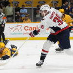 Washington Capitals' Anthony Mantha (39) shoots past the reach of Nashville Predators' Dante Fabbro (57) in the first period of an NHL hockey game Saturday, Oct. 29, 2022, in Nashville, Tenn. (AP Photo/Mark Humphrey)