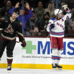 New York Rangers center Mika Zibanejad, right, celebrates after his goal as Arizona Coyotes defenseman Josh Brown (3) skates away during the third period of an NHL hockey game at Mullett Arena in Tempe, Ariz., Sunday, Oct. 30, 2022. (AP Photo/Ross D. Franklin)