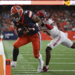 
              Syracuse running back Sean Tucker (34) is tackled out of bounds by North Carolina State cornerback Aydan White (3) during the first half of an NCAA college football game Saturday, Oct. 15, 2022, in Syracuse, N.Y. (AP Photo/Joshua Bessex)
            