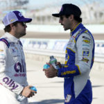 
              Drivers Noah Gragson, left and Chase Elliott, right, talk on pit road during NASCAR Cup Series practice at Homestead-Miami Speedway, Saturday, Oct. 22, 2022, in Homestead, Fla. (AP Photo/Lynne Sladky)
            