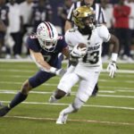 Colorado wide receiver Maurice Bell (13) tries to get away from Arizona safety Gunner Maldonado (9) during the first half of an NCAA college football game Saturday, Oct. 1, 2022, in Tucson, Ariz. (AP Photo/Rick Scuteri)