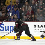 New York Rangers center Mika Zibanejad (93) gets the puck past Arizona Coyotes defenseman Josh Brown, center, and goaltender Connor Ingram (39) for a goal as Coyotes center Jack McBain (22) looks on during the third period of an NHL hockey game at Mullett Arena in Tempe, Ariz., Sunday, Oct. 30, 2022. (AP Photo/Ross D. Franklin)