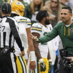 
              Side judge Dave Hawkshaw (107) listens to Green Bay Packers head coach Matt LaFleur during the first half of an NFL football game against the Washington Commanders, Sunday, Oct. 23, 2022, in Landover, Md. (AP Photo/Al Drago)
            