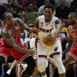 
              Chicago Bulls forward DeMar DeRozan (11) goes after a pass by Miami Heat guard Kyle Lowry (7) during the first half of an NBA basketball game Wednesday, Oct. 19, 2022, in Miami. (AP Photo/Marta Lavandier)
            