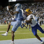 North Carolina wide receiver Antoine Green (3) pulls in a pass for a touchdown as he is defended by Pittsburgh defensive back A.J. Woods (25) during the second half of an NCAA college football game in Chapel Hill, N.C., Saturday, Oct. 29, 2022. (AP Photo/Chris Seward)