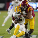 Arizona State quarterback Emory Jones, left, is sacked by Southern California defensive lineman Tyrone Taleni during the second half of an NCAA college football game Saturday, Oct. 1, 2022, in Los Angeles. (AP Photo/Mark J. Terrill)