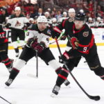 Ottawa Senators center Josh Norris (9) takes a shot on net as Arizona Coyotes left wing Matias Maccelli (63) defends during the second period of an NHL hockey game in Ottawa, Ontario on Saturday, Oct. 22, 2022. (Sean Kilpatrick/The Canadian Press via AP)