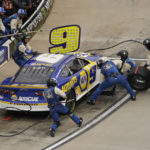 Crew members perform a pit stop on the car of Chase Elliott during a NASCAR Cup Series auto race at Martinsville Speedway, Sunday, Oct. 30, 2022, in Martinsville, Va. (AP Photo/Chuck Burton)
