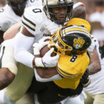 Vanderbilt's Anfernee Orji, top, tackles Missouri's Nathaniel Peat, bottom, during the first quarter of an NCAA college football game Saturday, Oct. 22, 2022, in Columbia, Mo. (AP Photo/L.G. Patterson)