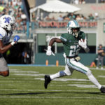 Tulane running back Tyjae Spears (22) runs the ball past Memphis linebacker Xavier Cullens (8) during the first half of an NCAA college football in New Orleans, Saturday, Oct. 22, 2022. (AP Photo/Tyler Kaufman)