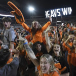 Oregon State fans storm the field after the team's win over Washington State in an NCAA college football game Saturday, Oct. 15, 2022, in Corvallis, Ore. (AP Photo/Mark Ylen)