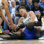 
              Boston Celtics' Blake Griffin, top center, and Orlando Magic's Kevon Harris, bottom center, battle for a the ball during the first half of an NBA basketball game, Saturday, Oct. 22, 2022, in Orlando, Fla. (AP Photo/John Raoux)
            