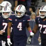 Arizona wide receiver Tetairoa McMillan (4) celebrates with offensive linemen Josh Baker (75) and Jordan Morgan (77) after scoring a touchdown against Colorado during the second half of an NCAA college football game Saturday, Oct. 1, 2022, in Tucson, Ariz. (AP Photo/Rick Scuteri)