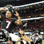Atlanta Falcons place kicker Younghoe Koo is congratulated by teammates after kicking a field goal overtime of an NFL football game to defeat the Carolina Panthers 37-34 Sunday, Oct. 30, 2022, in Atlanta. (AP Photo/John Bazemore)