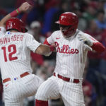 
              Philadelphia Phillies' Rhys Hoskins celebrates after a two-run home run with Kyle Schwarber during the fifth inning in Game 4 of the baseball NL Championship Series between the San Diego Padres and the Philadelphia Phillies on Saturday, Oct. 22, 2022, in Philadelphia. (AP Photo/Matt Rourke)
            