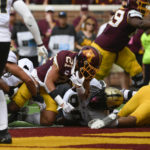 
              Minnesota running back Bryce Williams, center, dives into the end zone for a touchdown against Purdue during the second half of an NCAA college football game, Saturday, Oct. 1, 2022, in Minneapolis. Purdue won 20-10. (AP Photo/Craig Lassig)
            