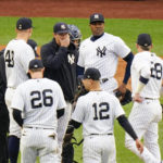 
              New York Yankees relief pitcher Aroldis Chapman, huddles with teammates during the seventh inning of a baseball game against the Baltimore Orioles, Sunday, Oct. 2, 2022, in New York. (AP Photo/Frank Franklin II)
            