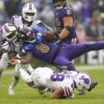 Baltimore Ravens quarterback Lamar Jackson (8) is brought down by Buffalo Bills linebackers Tremaine Edmunds and Matt Milano (58) in the second half of an NFL football game Sunday, Oct. 2, 2022, in Baltimore. (AP Photo/Julio Cortez)