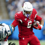 Arizona Cardinals running back James Conner breaks away from Carolina Panthers cornerback Jaycee Horn during the second half of an NFL football game on Sunday, Oct. 2, 2022, in Charlotte, N.C. (AP Photo/Jacob Kupferman)