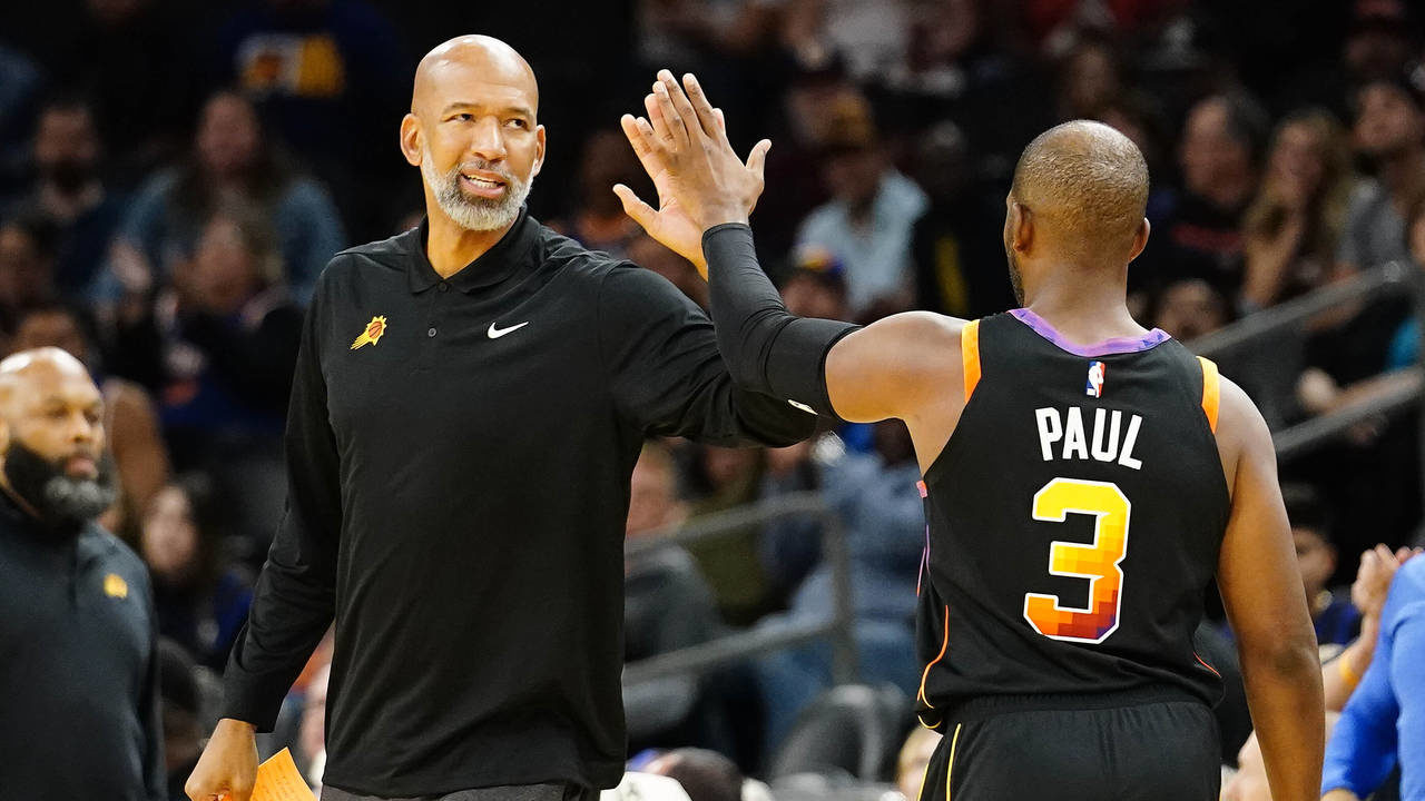 Phoenix Suns' head coach Monty Williams gives a high five to Chris Paul (3)  in the closing minutes...