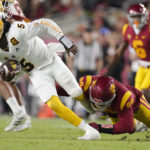 Arizona State quarterback Emory Jones, left, breaks away from an attempted sack by Southern California defensive lineman Nick Figueroa during the first half of an NCAA college football game Saturday, Oct. 1, 2022, in Los Angeles. (AP Photo/Mark J. Terrill)