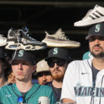 Seattle Mariners fans wear rally shoes on their heads during the eighth inning in Game 3 of an American League Division Series baseball game between the Seattle Mariners and the Houston Astros, Saturday, Oct. 15, 2022, in Seattle. (AP Photo/Stephen Brashear)