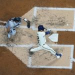Milwaukee Brewers' Christian Yelich hits a home run during the first inning of a baseball game against the Arizona Diamondbacks Monday, Oct. 3, 2022, in Milwaukee. (AP Photo/Morry Gash)