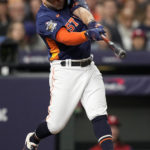 Houston Astros' Jose Altuve hits a double during the first inning in Game 2 of baseball's World Series between the Houston Astros and the Philadelphia Phillies on Saturday, Oct. 29, 2022, in Houston. (AP Photo/David J. Phillip)