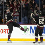 Arizona Coyotes center Nick Bjugstad, left, celebrates his goal against the New York Rangers with Coyotes left wing Matias Maccelli (63) during the second period of an NHL hockey game at Mullett Arena in Tempe, Ariz., Sunday, Oct. 30, 2022. (AP Photo/Ross D. Franklin)