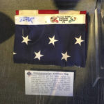 
              This image provided by Dan Vitale shows a U.S. flag signed by quarterback Tom Brady. Vitale, the owner of the flag, sued the New England Patriots on Wednesday, Oct. 5, 2022, saying the team caused irreparable damage to the flag by improperly displaying it at the team's hall of fame at Gillette Stadium. The suit contends that after the flag had been on display for a couple of months, Brady’s signature written in blue Sharpie had significantly faded, which reduced the flag’s value by as much as $1 million. (Dan Vitale via AP)
            