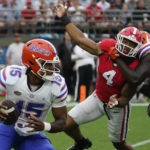 
              Florida quarterback Anthony Richardson (15) looks for a receiver as he is pressured by Georgia linebacker Nolan Smith (4) during the first half of an NCAA college football game Saturday, Oct. 29, 2022, in Jacksonville, Fla. (AP Photo/John Raoux)
            