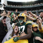 Green Bay Packers wide receiver Romeo Doubs (87) celebrates with fans after catching a 13-yard touchdown pass during the second half of an NFL football game against the New England Patriots, Sunday, Oct. 2, 2022, in Green Bay, Wis. (AP Photo/Morry Gash)