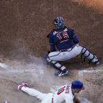 Philadelphia Phillies catcher J.T. Realmuto (10) slides into home for a home run during the third inning in Game 4 of baseball's National League Division Series between the Philadelphia Phillies and the Atlanta Braves, Saturday, Oct. 15, 2022, in Philadelphia. (AP Photo/Matt Slocum)