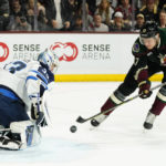 Winnipeg Jets goaltender David Rittich (33) slides over to make a save on a shot by Arizona Coyotes center Nick Bjugstad (17) during the first period of an NHL hockey game at Mullett Arena in Tempe, Ariz., Friday, Oct. 28, 2022. (AP Photo/Ross D. Franklin)