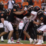 
              Oklahoma State's Jake Springfield (61) and Jake Schultz (38) lift Dominic Richardson (20) into the end zone for a touchdown during the second half of an NCAA college football game against Texas Tech in Stillwater, Okla., Saturday, Oct. 8, 2022. (AP Photo/Mitch Alcala)
            