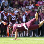 Virginia Tech's Kaleb Smith (80) is upended after catching a pass in the second half of an NCAA football game against Miami, Saturday Oct. 15 2022,  in Blacksburg Va. (Matt Gentry/The Roanoke Times via AP)