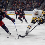 
              Pittsburgh Penguins forward Bryan Rust, right, passes in front of Columbus Blue Jackets defensman Nick Blankenburg during the first period of an NHL hockey game in Columbus, Ohio, Saturday, Oct. 22, 2022. (AP Photo/Paul Vernon)
            