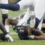 
              Seattle Seahawks quarterback Geno Smith is turned upside down after being sacked by New Orleans Saints defensive end Cameron Jordan, background, during an NFL football game in New Orleans, Sunday, Oct. 9, 2022. (AP Photo/Gerald Herbert)
            