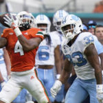 
              Miami running back Jaylan Knighton (4) catches a pass against North Carolina linebacker Cedric Gray (33) during the first half of an NCAA college football game, Saturday, Oct. 8, 2022, in Miami Gardens, Fla. (AP Photo/Wilfredo Lee)
            