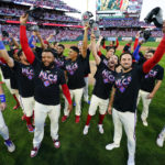 The Philadelphia Phillies pose for a photo after a win over the Atlanta Braves in Game 4 of baseball's National League Division Series, Saturday, Oct. 15, 2022, in Philadelphia. The Philadelphia Phillies won, 8-3.(AP Photo/Matt Rourke)
