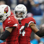 Arizona Cardinals safety Jalen Thompson (34) celebrates with safety Budda Baker after an interception against the Carolina Panthers during the first half of an NFL football game on Sunday, Oct. 2, 2022, in Charlotte, N.C. (AP Photo/Rusty Jones)