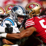 Carolina Panthers running back Christian McCaffrey is tackled by the San Francisco 49ers during the first half an NFL football game on Sunday, Oct. 9, 2022, in Charlotte, N.C. (AP Photo/Jacob Kupferman)