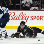 Arizona Coyotes center Nick Bjugstad (17) loses the puck as he gets hit by Winnipeg Jets defenseman Josh Morrissey (44) during the third period of an NHL hockey game at Mullett Arena in Tempe, Ariz., Friday, Oct. 28, 2022. The Jets won 3-2 in overtime. (AP Photo/Ross D. Franklin)