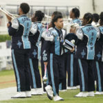 Jackson State's first Latino drum major Marvin Meda walks past the school's "Sonic Band of The South" band as they practice before an NCAA college football game between Jackson State and Southern in Jackson, Miss., Saturday, Oct. 29, 2022. (AP Photo/Rogelio V. Solis)