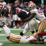 
              Atlanta Falcons quarterback Marcus Mariota (1) is sacked by San Francisco 49ers defenders during the first half of an NFL football game, Sunday, Oct. 16, 2022, in Atlanta. (AP Photo/Brynn Anderson)
            